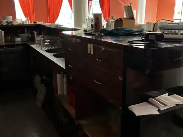 Avant travaux : comptoir existant, verres suspendus au-dessus du bar.